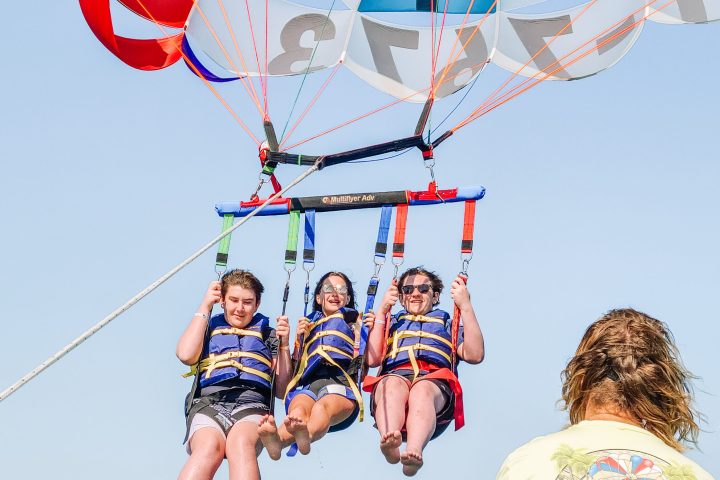 three people parasailing