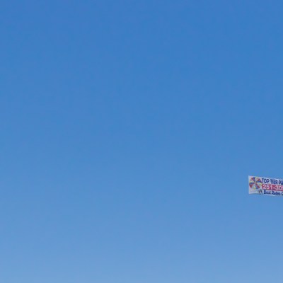 a sign on a clear blue sky