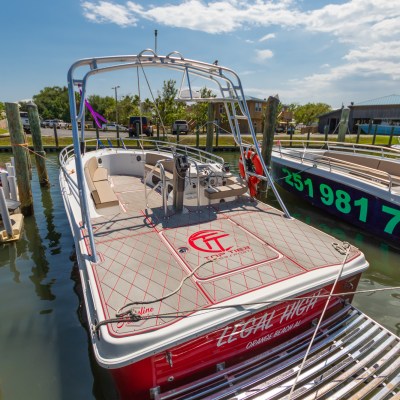 a boat sitting on top of a wooden dock over some water
