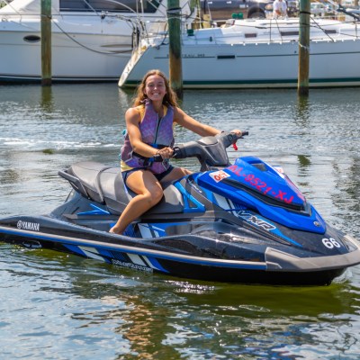a person riding on the back of a boat in the water