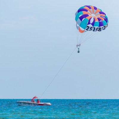 a boat with a parasailing parachute